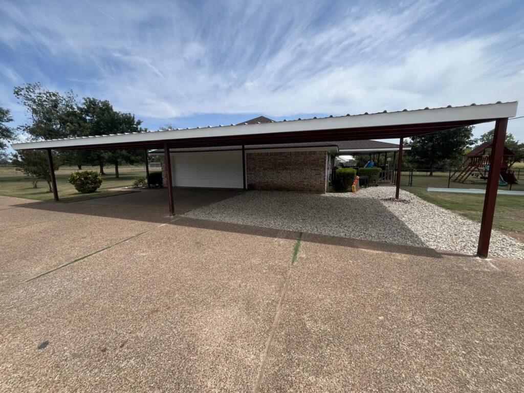 Triple carport installed for three trucks with vertical paneling